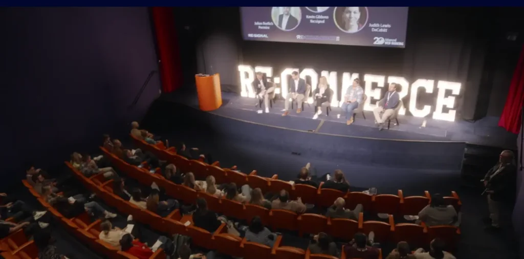 A photo inside a hall full of attendees during a Re:Commerce event
