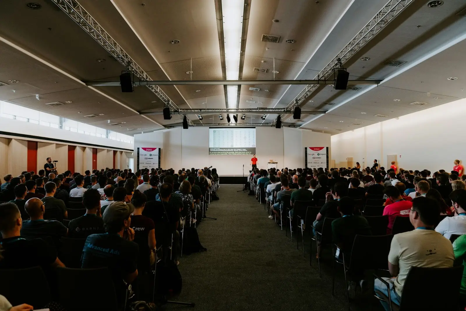 A group of attendees gathered inside a hall during an SEO conference event